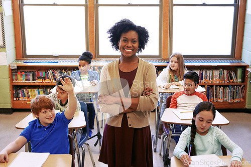 Image of Portrait, teacher and education with a black woman in a classroom, standing arms crossed with her students. School, learning or study with a female educator in a class with a boy and girl pupils