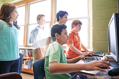 Image of Diversity, education or children in classroom on computer for learning, tech research or website search. Scholarship, thinking or students in school library for social network, academy or assessment