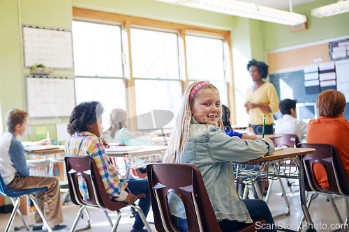 Image of Classroom, children and education portrait of a girl writing to learn, study and gain knowledge. Diversity group students or kids in language class while learning for future, development and growth