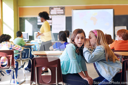 Image of School, friends and whispering in classroom for secret, gossip or chatting during teaching lesson. Sneaky female learners sharing quiet information secretly in ear at class while teacher is busy