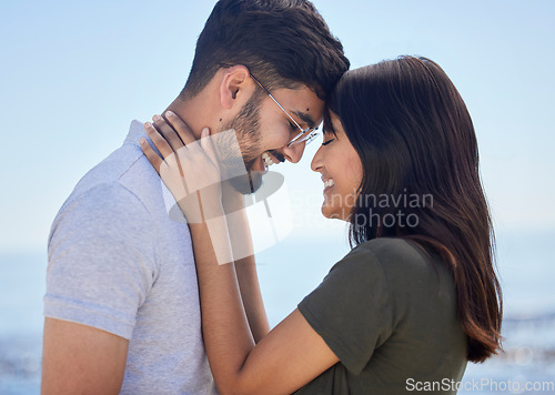 Image of Love, couple and hug at beach with travel and care on summer holiday by the ocean, commitment and support outdoor. Young, happy and relationship with romantic date, man and woman profile on vacation