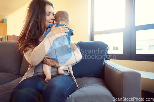 Image of Mom, bonding and baby girl hug in house living room or family home sofa in support trust, love and security. Smile, infant or happy mother holding child or kid in embrace to stop crying or help sleep