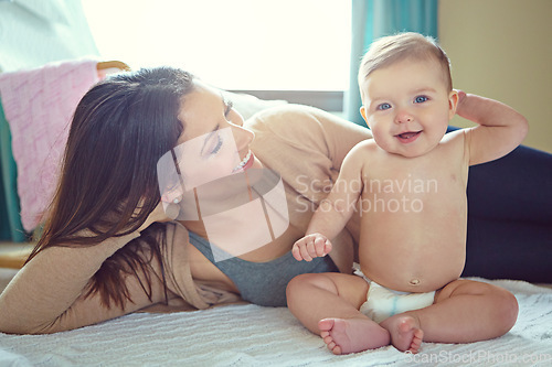 Image of Mom, baby girl or bonding in bedroom of house or family home in support trust, love and security in diapers. Smile, child or happy mother in infant healthcare wellness, changing clothes or after bath