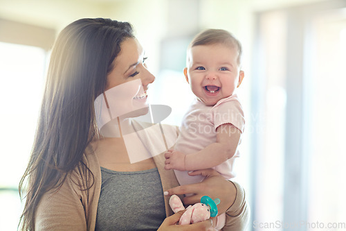 Image of Mother, carrying or laughing baby girl in house living room, nursery or family home bedroom in trust, love or support. Smile, happy mom or infant child in funny, goofy and comic bonding game for kids