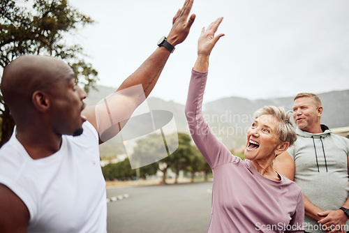 Image of Fitness, high five and diversity friends or people with support, accountability and teamwork in nature training, exercise or workout. Wellness, community and senior with target, success or goal sign