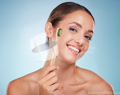 Image of Brushing teeth, dental and woman with toothbrush for teeth whitening and beauty, oral health and fresh breath with studio background. Mouth wellness, Invisalign portrait and clean with bamboo brush.