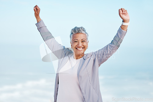 Image of Fitness, hands in air and senior woman for exercise, fitness or workout portrait goals, success and achievement on blue sky mockup. Winner, freedom and healthy celebration of elderly runner in nature