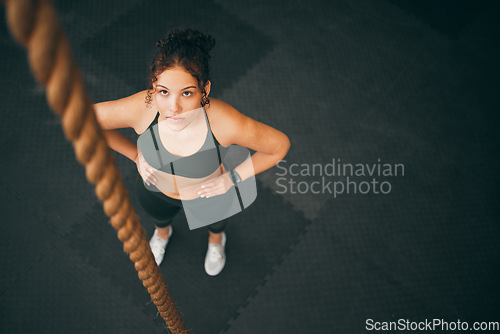 Image of Rope climbing, gym and fitness woman with focus for sports challenge, full body workout and healthy training. Female athlete, climb exercise and top view with power, strong mindset and motivation