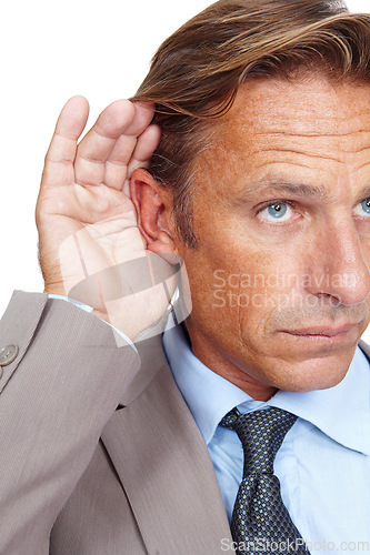 Image of Hear, secret and businessman holding his ear in a studio while listening to a whisper conversation. Communication, listen and corporate male model hearing a discussion isolated by a white background.