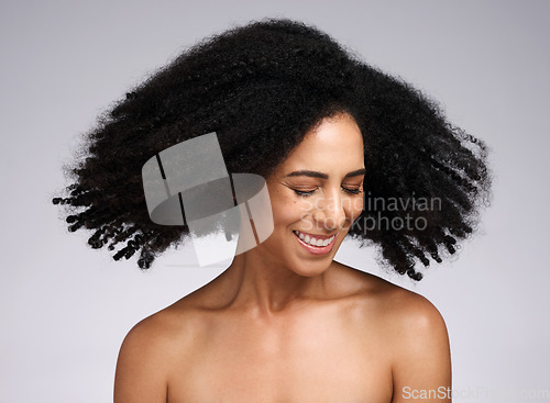 Image of Beauty, black woman and afro shake for hair care campaign with playful smile and natural texture. Happiness, wellness and hair volume of african model with healthy skincare in white studio.