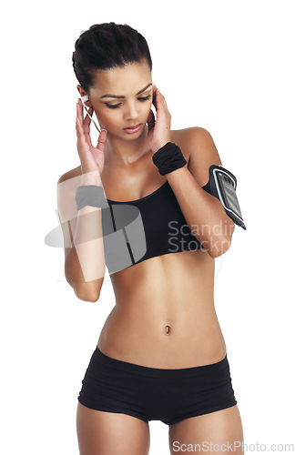 Image of Music, fitness and sports with woman and phone for workout, health and cardio training. Podcast, mobile radio and motivation with isolated girl listening to earphones for exercise, streaming and goal