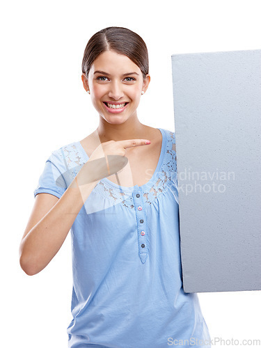 Image of Portrait, pointing and blank sign with a woman in studio isolated on a white background holding a poster for branding. Logo, marketing and brand with a female showing mockup space for advertising