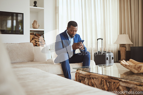 Image of African businessman on phone in hotel room, reading email on smartphone and corporate professional in Chicago. Black entrepreneur typing message, luxury accommodation in city and hospitality travel