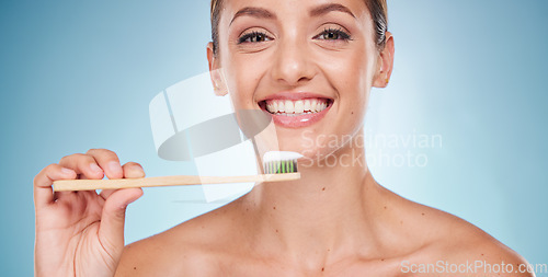 Image of Brushing teeth, dental and woman with toothbrush for teeth whitening and beauty, oral health and fresh breath with studio background. Mouth wellness, Invisalign portrait and clean with bamboo brush.