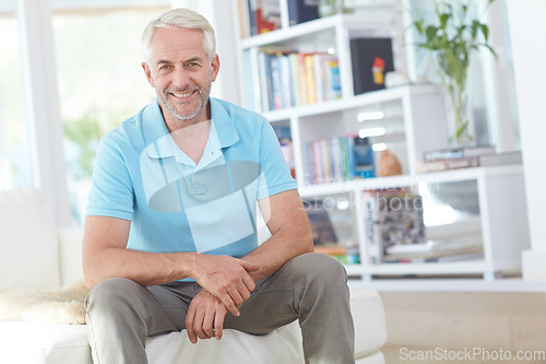 Image of Senior man, sitting and smile in living room relaxing at home on sofa enjoying happy retirement. Portrait of elderly male smiling in relax on couch for holiday, weekend or satisfaction at the house