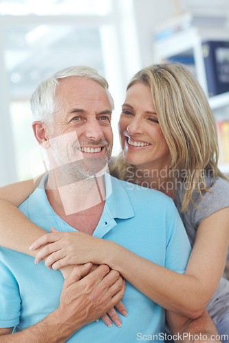 Image of Senior couple, happy and laughing in their home with love, care and support for retirement lifestyle. Commitment of a funny man and woman in a marriage with trust and security on a living room couch