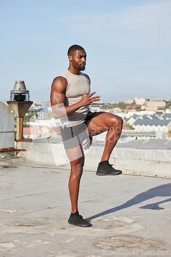 Image of Health, fitness and black man stretching legs outdoors on city rooftop alone. Sports, training and male athlete warm up, preparing and getting ready for workout, running or exercise for wellness.
