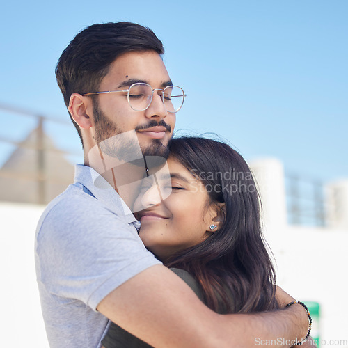 Image of Love, beach and happy couple hug, relax and enjoy outdoor quality time together for peace, freedom and romantic date. Happiness, sky and man and woman bond on travel holiday in Rio de Janeiro Brazil