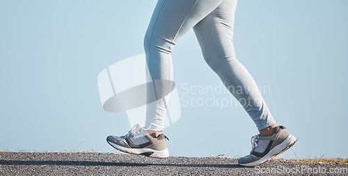 Image of Fitness, nature and legs of a woman running for health, wellness and endurance training in the street. Sports, workout and female athlete doing a cardio exercise for a race, marathon or competition.