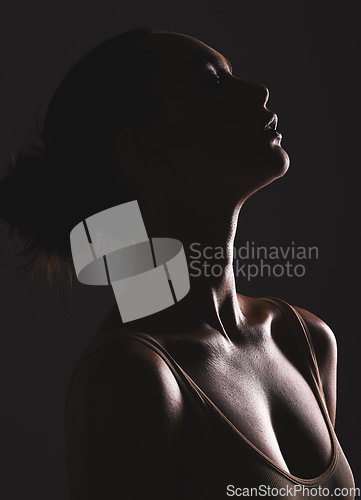 Image of Woman beauty silhouette, face and dark, sexy with cosmetics and seductive fantasy with mysterious aesthetic. Female profile with skin, sexy woman facial and shadow against black studio background.