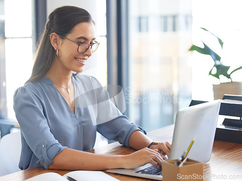 Image of Business woman, laptop and typing report or copywriting with copywriter, creative and working at desk. Internet, digital marketing and seo with happy woman writing, office and marketing agency