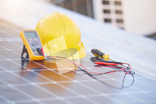 Image of Tools, solar panels or helmet on roof for solar energy installation in a city development project. Voltmeter, Construction, renewable energy or electric engineering equipment for building maintenance