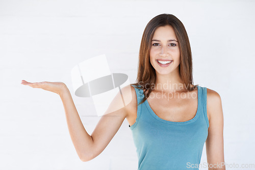 Image of Mockup gesture, studio portrait and woman with sales promotion, luxury present gift or discount deal mock up. Marketing space, product placement or advertising model isolated on white background wall