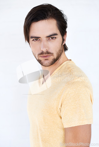 Image of Portrait, model and fashion with a man in studio isolated on a white background for a magazine cover or style. Fashion model, marketing and advertising with a male on blank branding space