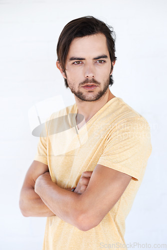 Image of Man, vertical and thinking with casual fashion and arms crossed with isolated white background. Studio, person and adult with tshirt and beard feeling calm and relax think and standing with mockup