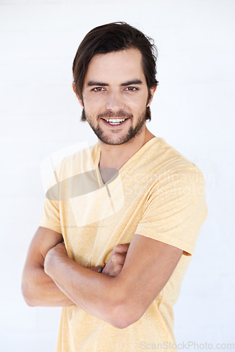 Image of Happy, man and portrait of a model with casual tshirt and vertical white background. Isolated, arms crossed and person smiling and feeling positive with happiness alone and comfortable fashion