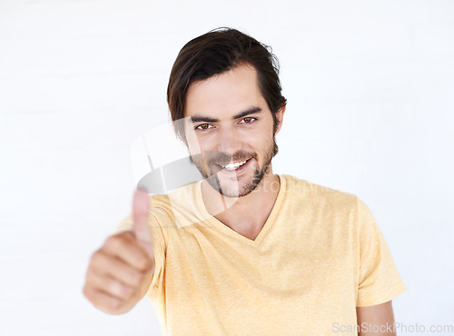 Image of Thumbs up, winner and portrait of man in studio, white background or isolated emoji. Male model, thumb up and support of yes agreement, celebration and hand sign, vote or trust, thank you and success