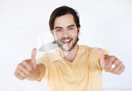 Image of Thumbs up, success and portrait of man in white background, studio or isolated emoji. Male model, thumb up and support of yes agreement, celebration and hand sign, vote or trust, thank you and winner