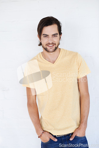 Image of Handsome young man, smile and hands in pocket for casual fashion against white studio background. Portrait of isolated attractive male standing and smiling in happiness or profile on white background