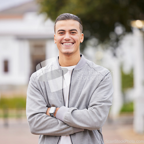 Image of Education, smile and college with portrait of man on campus with arms crossed for learning, scholarship or knowledge. Study, future or university with student back to school for academy, exam or goal