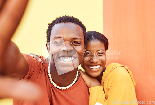 Image of Selfie, love and memories with a black couple posing for a photograph together on a color wall background. Portrait, happy and smile with a man and woman taking a picture while bonding outside