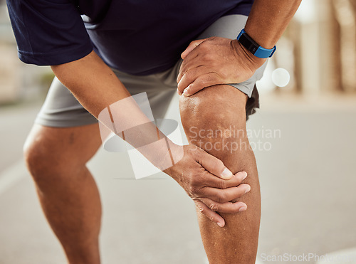 Image of Fitness, knee pain and hands of black man with muscle ache, painful joint and injury after running in city. Sports, body wellness and male athlete rest after workout, marathon training and exercise