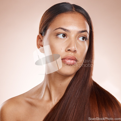 Image of Hair care, shine and woman thinking of shampoo, hairdresser glow and results from a hair salon on a studio background. Keratin, long hair and face of a model marketing an idea for natural hair health