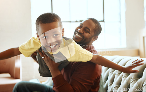 Image of Family, portrait and father with son on the the sofa for airplane, game and bonding in their home. Love, parent and child playing in living room, smile and relax while boy enjoy fly, fun and weekend