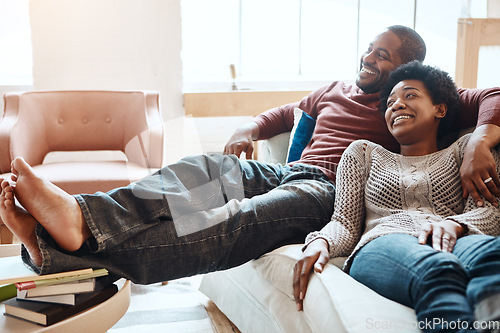 Image of Couple, relax and watching tv on a sofa, happy and smile while bonding in their home together. Television, resting and black woman with man on a sofa, resting and having fun in the living room