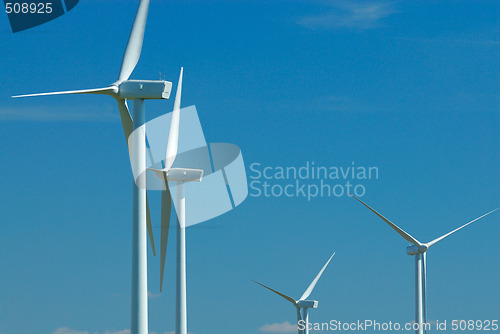 Image of four windturbines on blue sky