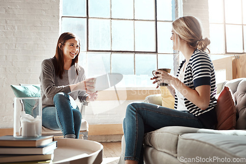 Image of Woman, friends and smile for coffee, conversation or social catch up relaxing together on living room sofa at home. Happy women enjoying tea time, chatting or gossip with drink in apartment on couch