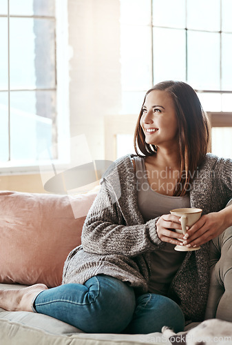 Image of Relax, coffee and woman on a living room couch feeling calm and peace at home. Tea, happiness and smile of a person in the morning thinking with gratitude of peaceful lounge day in a house smiling