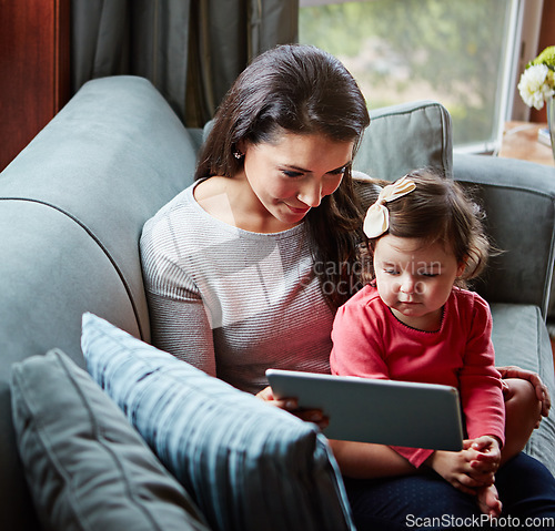 Image of Mother, baby and tablet for video call on sofa in living room for online communication or mobile virtual chat in family home. Mom smile, child and streaming web call on digital tech device on couch