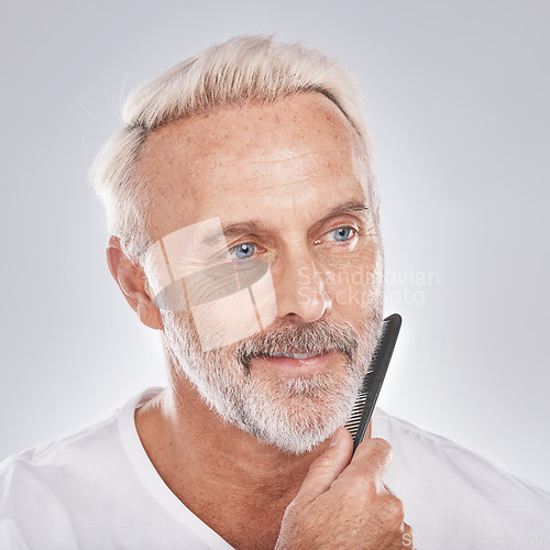 Image of Beard comb, mature man and face on studio background for growth maintenance, barber cleaning and healthy skincare. Male model, facial and brushing hair care for beauty, aesthetic fashion or cosmetics