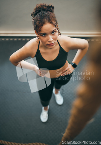 Image of Rope climbing, gym and fitness of woman ready for sports challenge, full body workout and training workout. Female athlete, portrait and climb exercise with focus, strong mindset and goal motivation