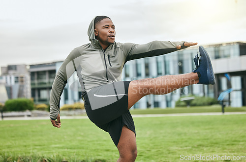 Image of Fitness, running and stretching with a sports black man getting ready for exercise in a park during summer. Health, workout and start with a male athlete training on grass for cardio or endurance