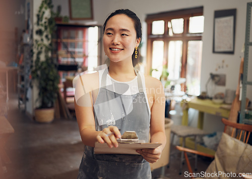 Image of Asian woman, clipboard and creative business owner with smile for art, design or startup in the workshop. Happy Japanese woman smiling for management, inspection or checklist for arts and crafts