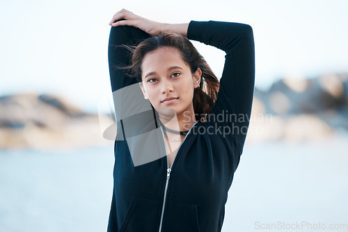 Image of Portrait, exercise and woman stretching, workout and fitness for wellness, health and cardio performance outdoor. Female, girl and athlete stretch arms, training and motivation for sports and healthy