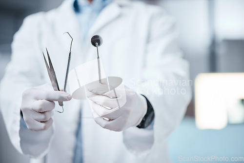 Image of Dentist hands with tools, teeth and mouth care with cleaning, oral hygienist and surgery for tooth decay. Teeth whitening equipment, metal and medical with oral health and dentistry clinic