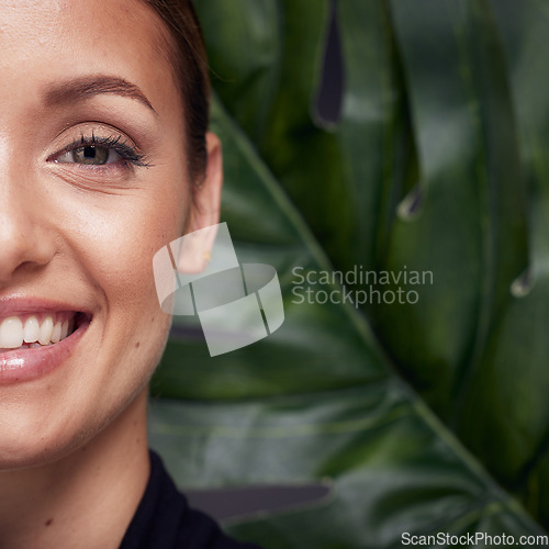 Image of Beauty, skin and face with leaf and woman, skincare with nature aesthetic, natural cosmetics and facial portrait against studio background. Smile, glow with organic cosmetic plant and wellness.